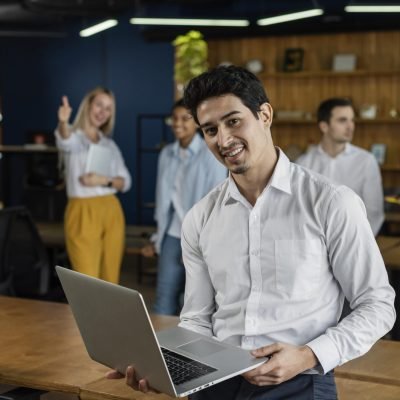 smiley-man-work-holding-laptop-posing